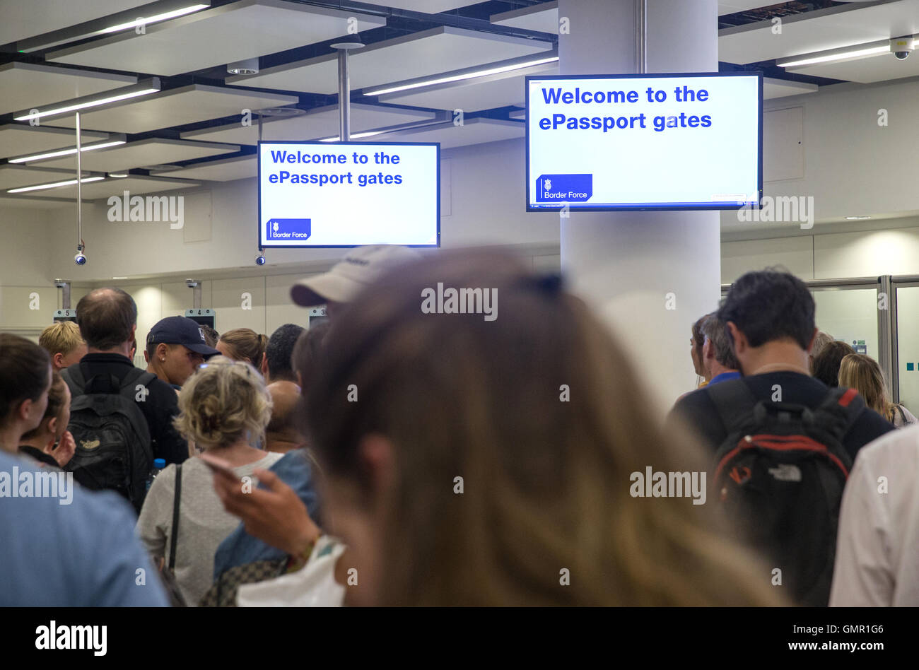 Le persone in fila al confine del regno unito al controllo dell'immigrazione a Gatwick South Terminal Foto Stock