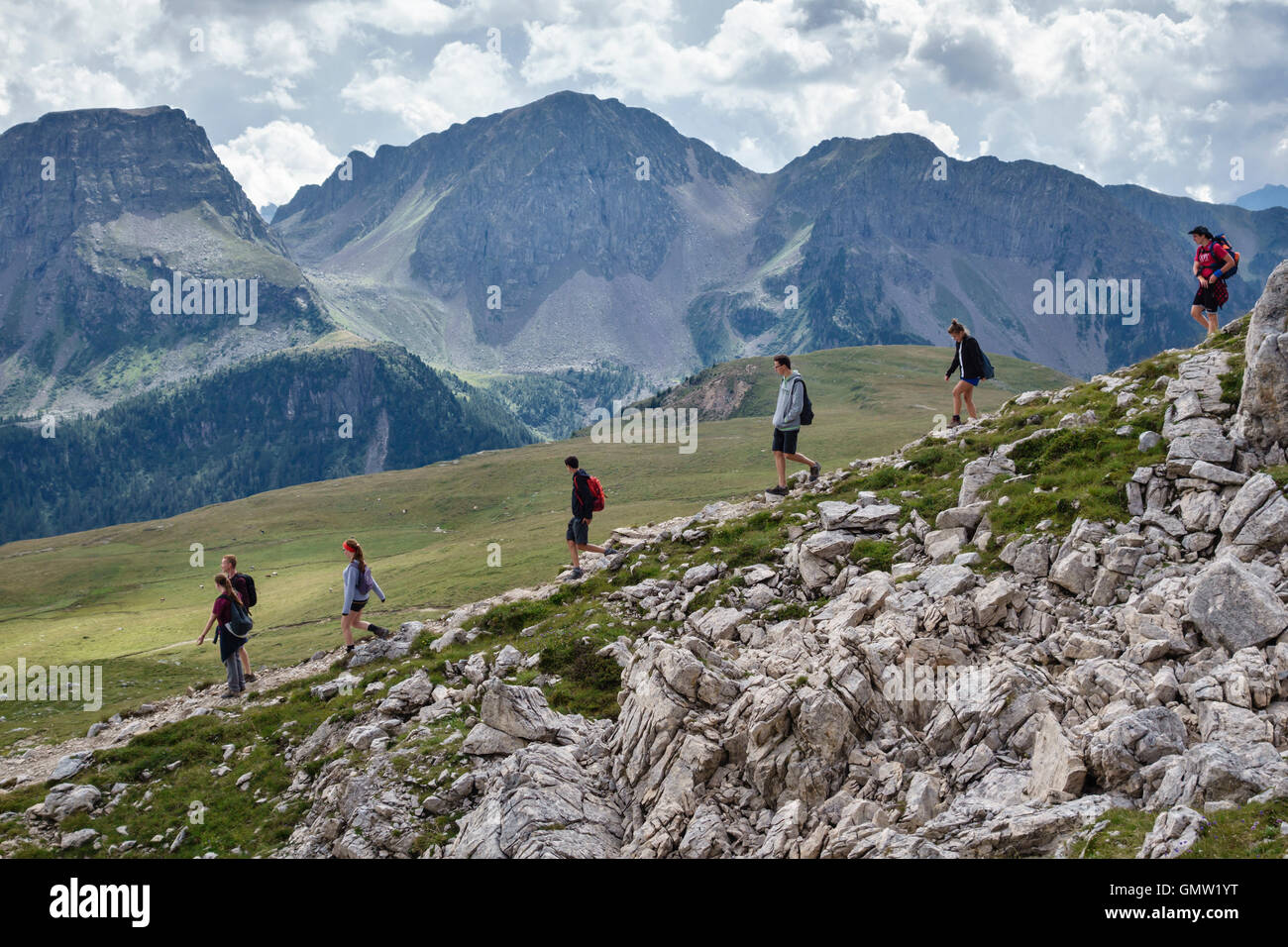 Le Dolomiti, Trentino, Italia settentrionale. Gli adolescenti a piedi giù dal Rifugio Passo delle Selle sopra il Passo San Pellegrino Foto Stock