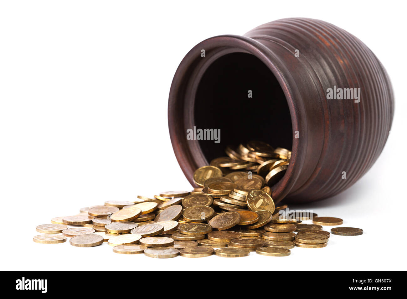 Le monete d'oro di cadere fuori dal pot Foto Stock