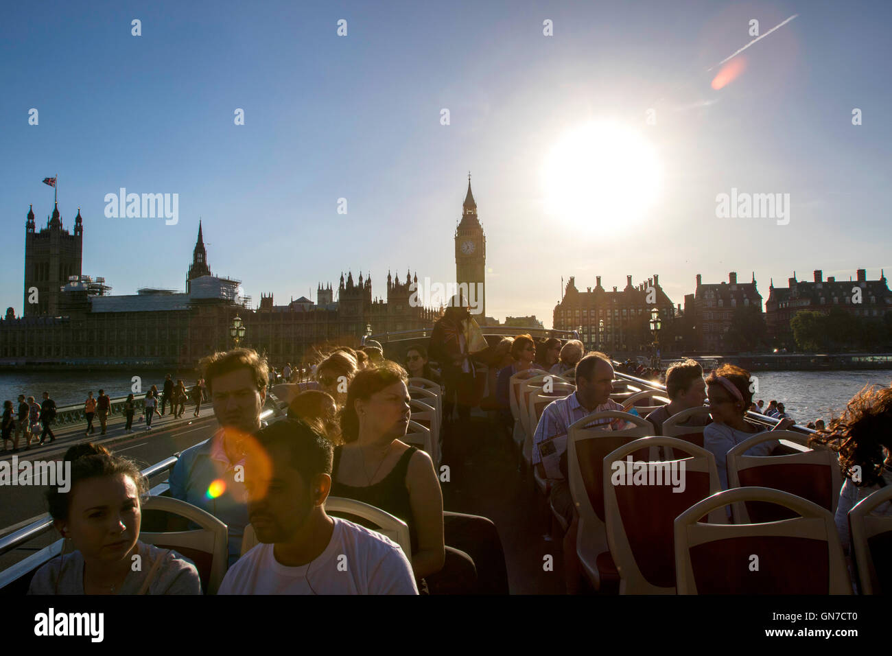 I turisti sul bus aperti guardando il Big Ben all'estremità nord del Palazzo di Westminster a Londra in estate con il blu del cielo Foto Stock