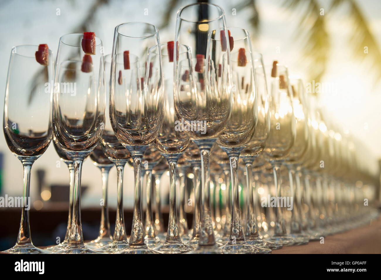 Gruppo di vuoto bicchieri da cocktail con focolare forma di cocomero sulla sommità preparando sulla tavola per la festa. Foto Stock