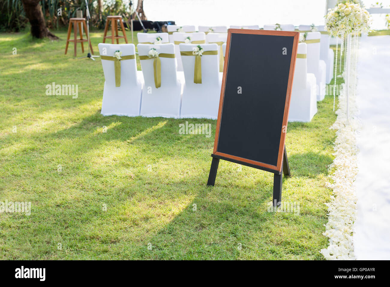 Vuoto segno lavagna marrone con telaio in legno nella parte anteriore di cerimonia nuziale. Decorazioni per matrimoni Foto Stock