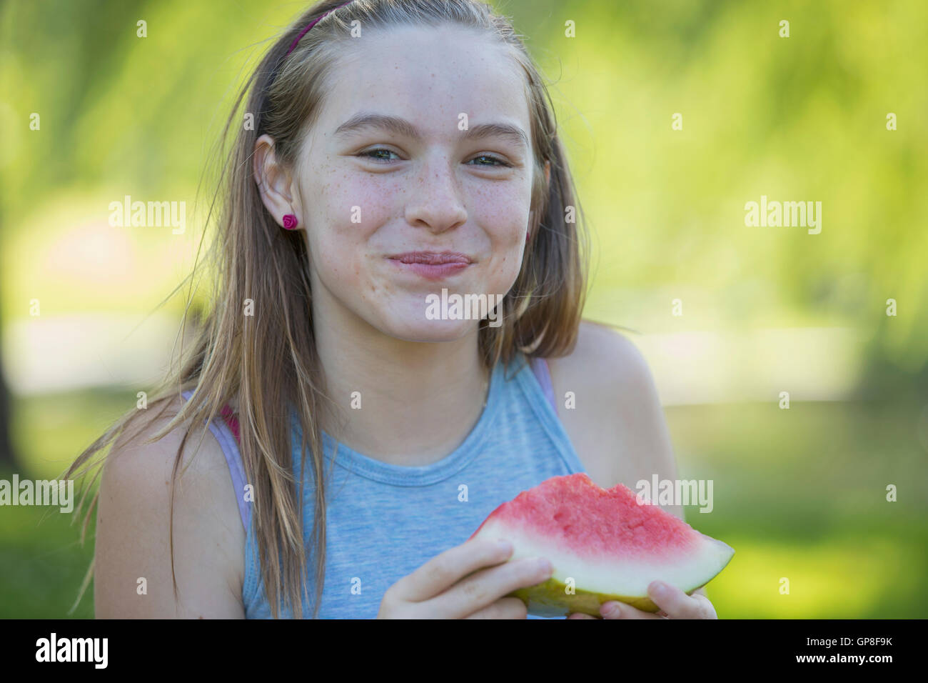 Ritratto di felice ispanica girl teen mangiando anguria Foto Stock