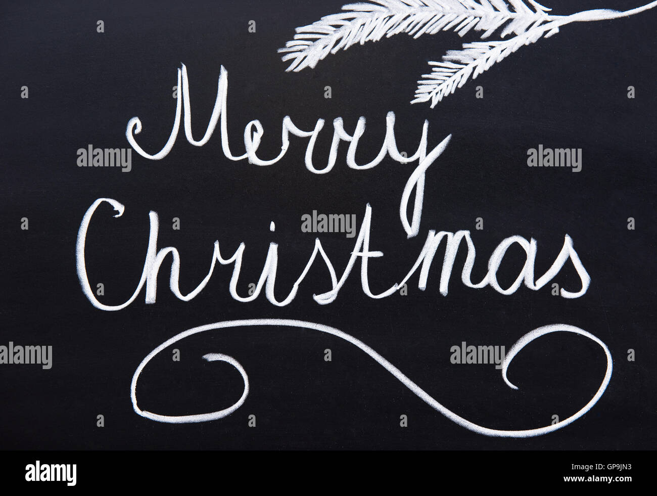 Buon Natale scritti su una lavagna con gesso Foto Stock