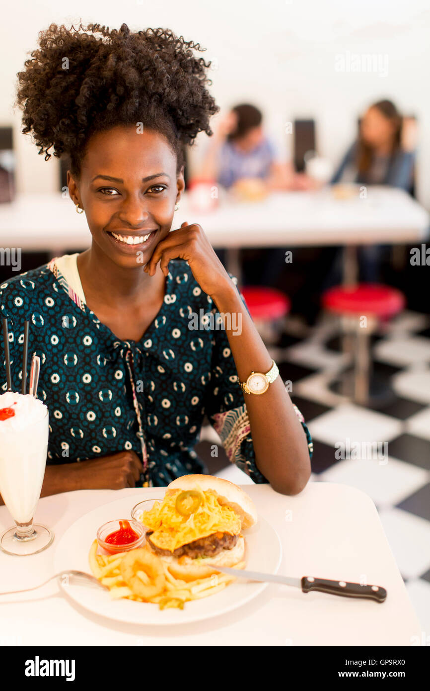 Giovane africano donna americana nel diner Foto Stock