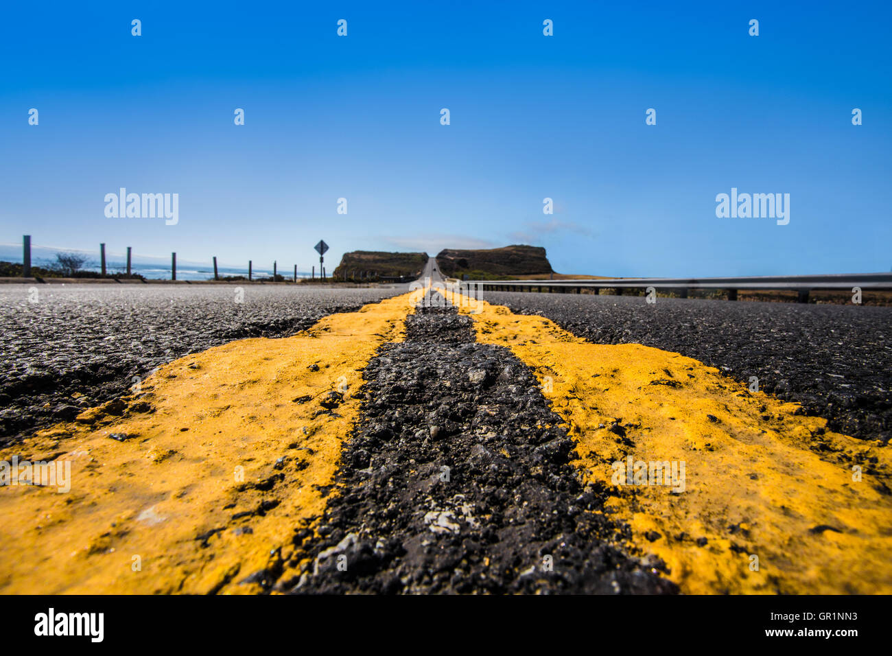 Strada giallo linee divisorie su asfalto da basso in prospettiva e punto di fuga Foto Stock