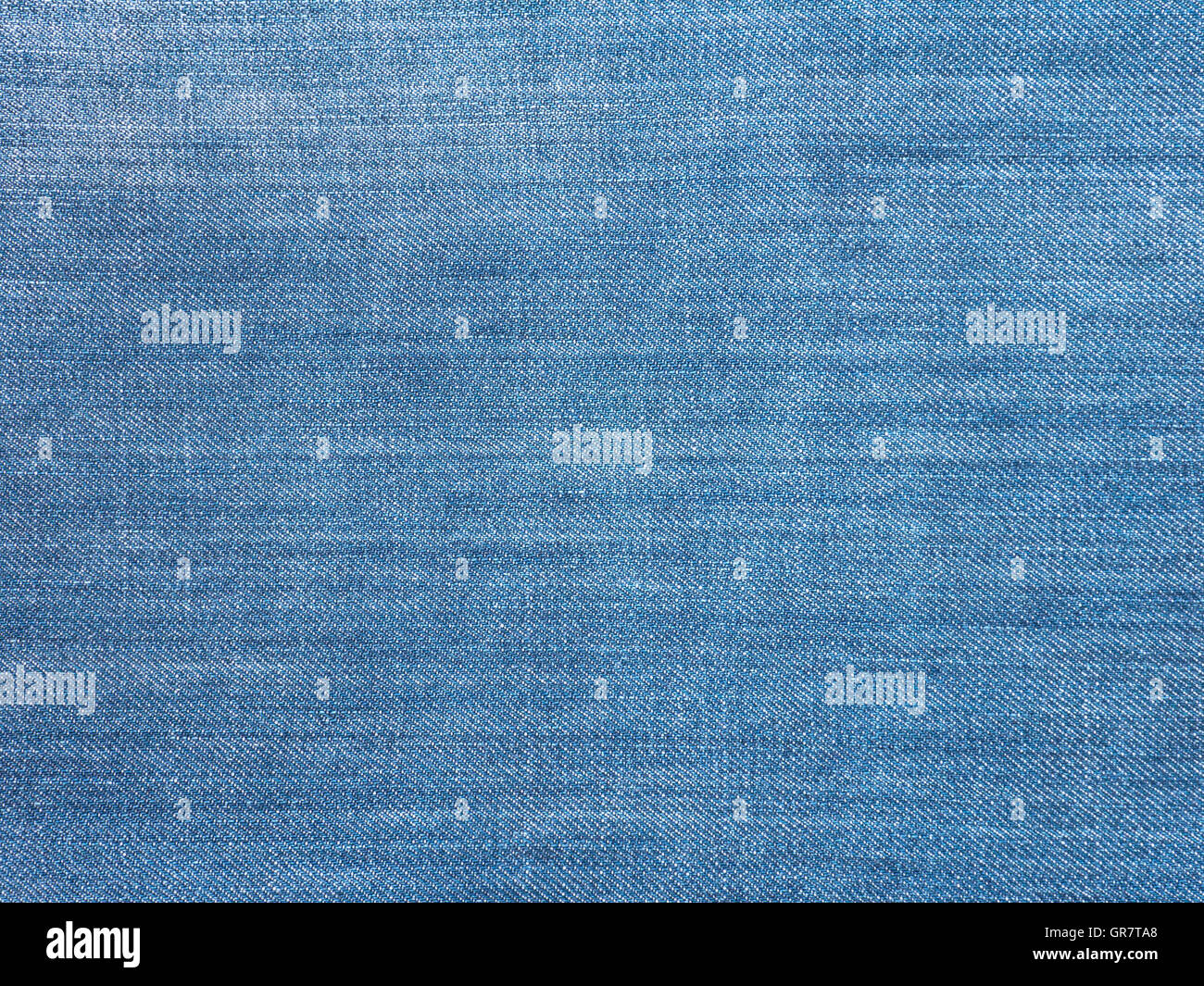 Luce blu lavato sbiadito di tessuto denim sfondo Foto Stock
