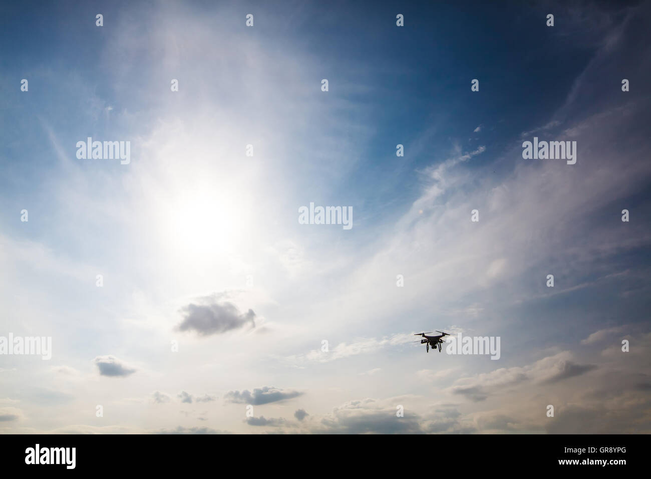 Fatto quad copter battenti in bilico nel cielo blu, silhouette Foto Stock