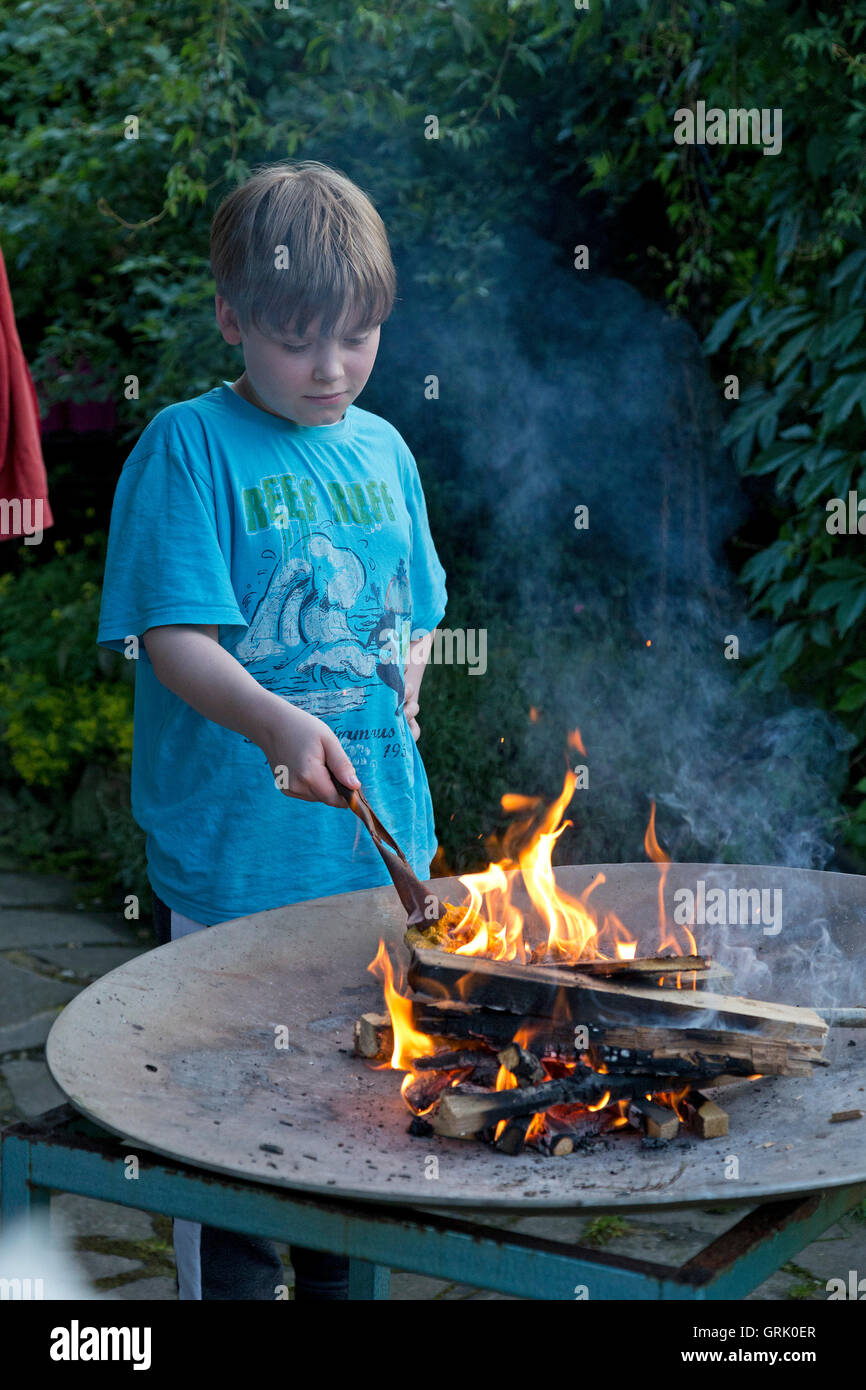 Giovane ragazzo giocando con il fuoco Foto Stock