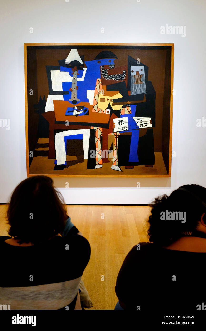 I visitatori di fronte di Pablo Picasso tre musicisti nel Museo di Arte Moderna MoMA aka. New York City.USA Foto Stock
