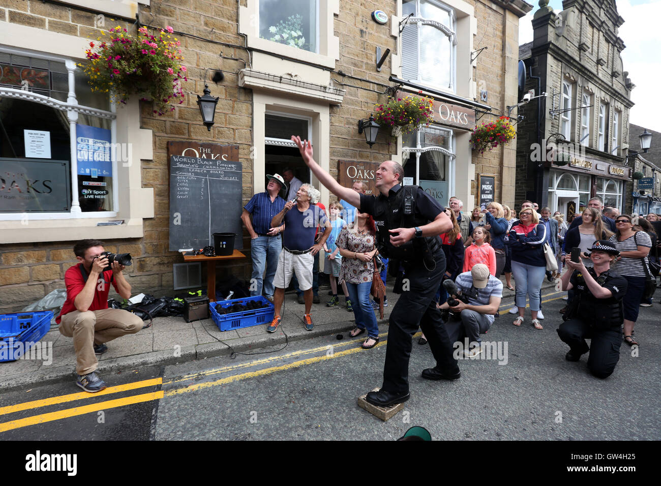 Ramsbottom, UK. 11 Settembre, 2016. PC Andy Fergusson, un'area Sgt da seppellire la polizia prende parte alla Black Pudding Lobbing campionati come il suo collega prende una foto di lui in Ramsbottom, Lancashire, 11 settembre 2016 Credit: Barbara Cook/Alamy Live News Foto Stock