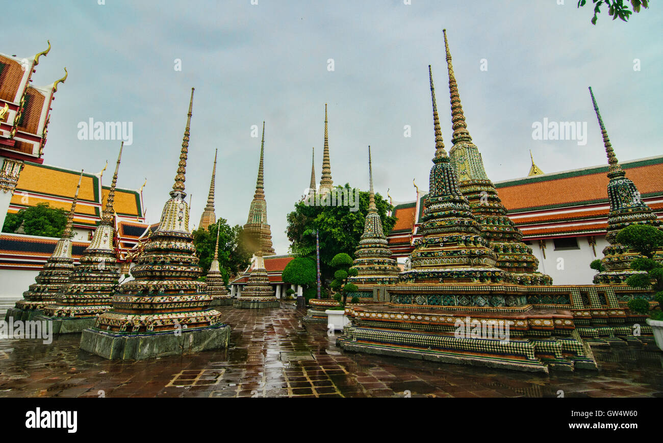 Gli stupa sotto la pioggia al Wat Pho tempio a Bangkok in Tailandia Foto Stock