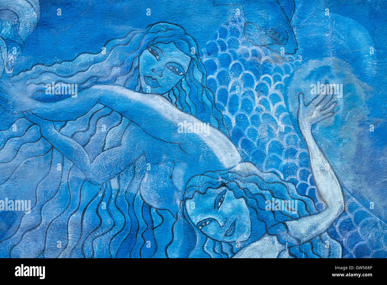 Dipinti murali di sirene e creature del mare lungo la costa di Puerto Ayora nelle isole Galapagos dell Ecuador Foto Stock