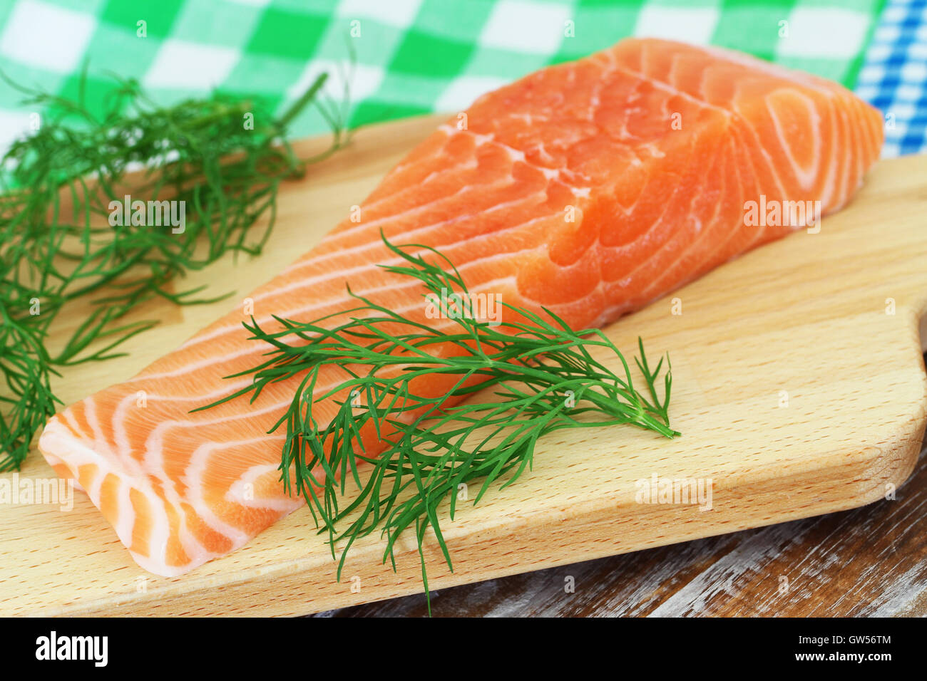 Raw bistecca di salmone su tavola di legno e di aneto fresco Foto Stock