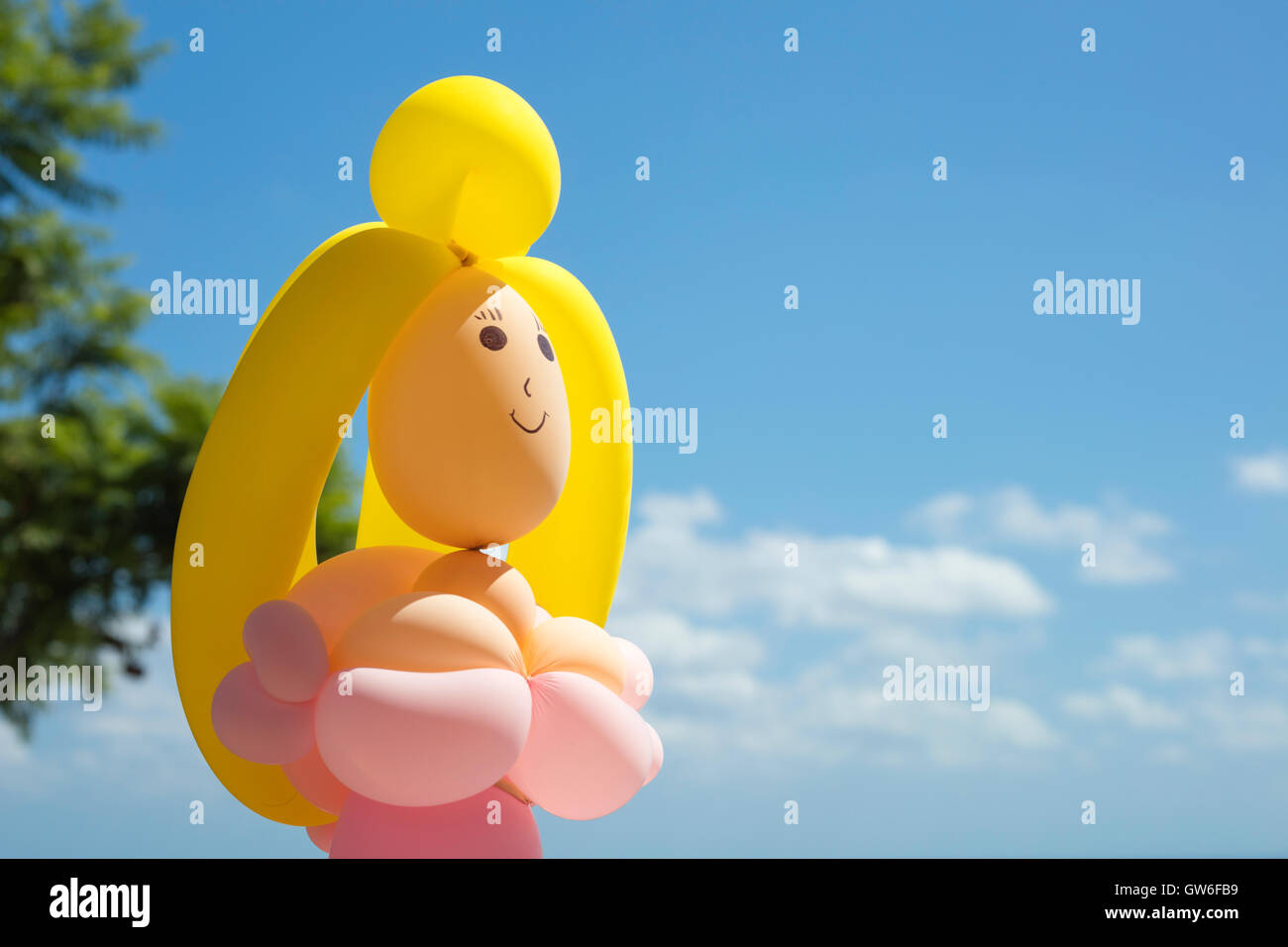 Dettaglio di un palloncino a forma di bambola femmina sorridente e guardando il cielo. Foto Stock