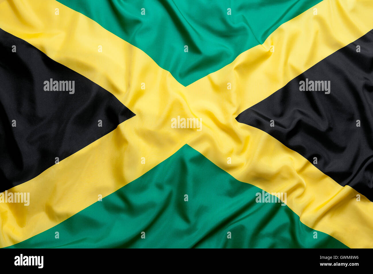 Bandiera tessile della Giamaica per uno sfondo Foto Stock