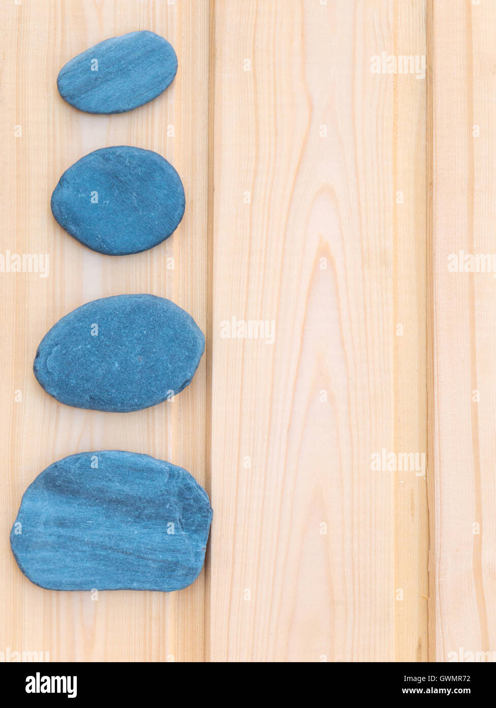 Quattro grigio scuro pietre di ardesia su tavole di legno, sfondo Foto Stock