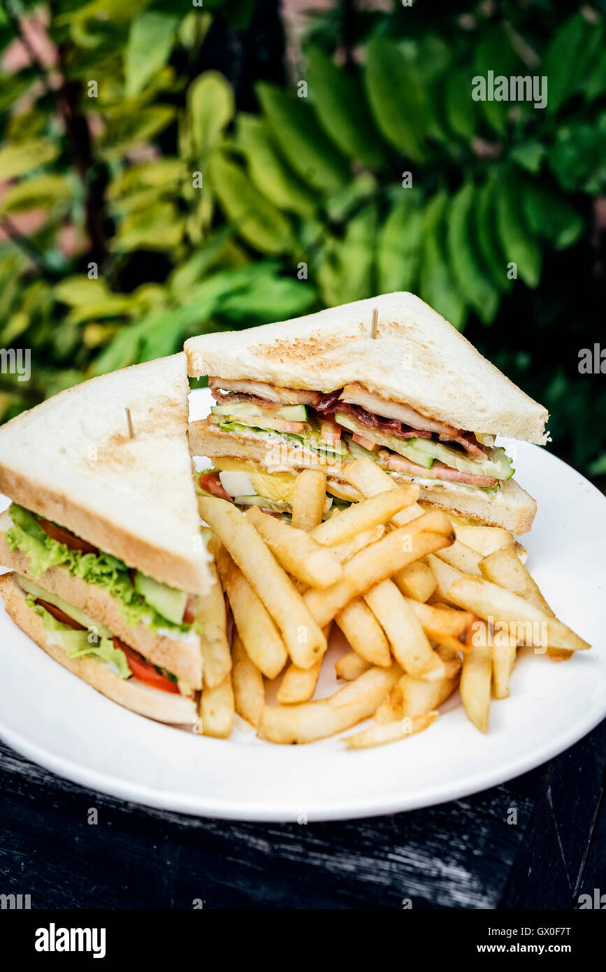 Club sandwich snack con patatine fritte su piastra Foto Stock