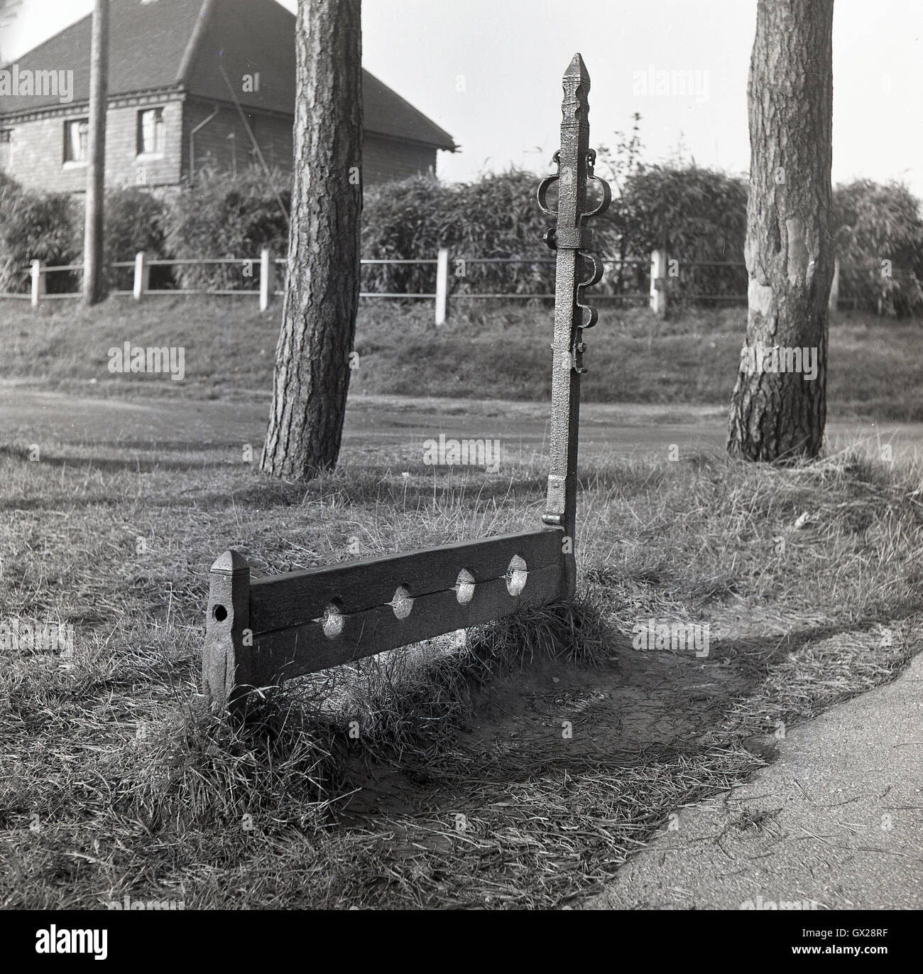 Degli anni Cinquanta, storico antico stock di legno per bloccare i piedi in luogo. Usato nel medioevo come una forma di punizione fisica che coinvolgono l'umiliazione pubblica. Foto Stock