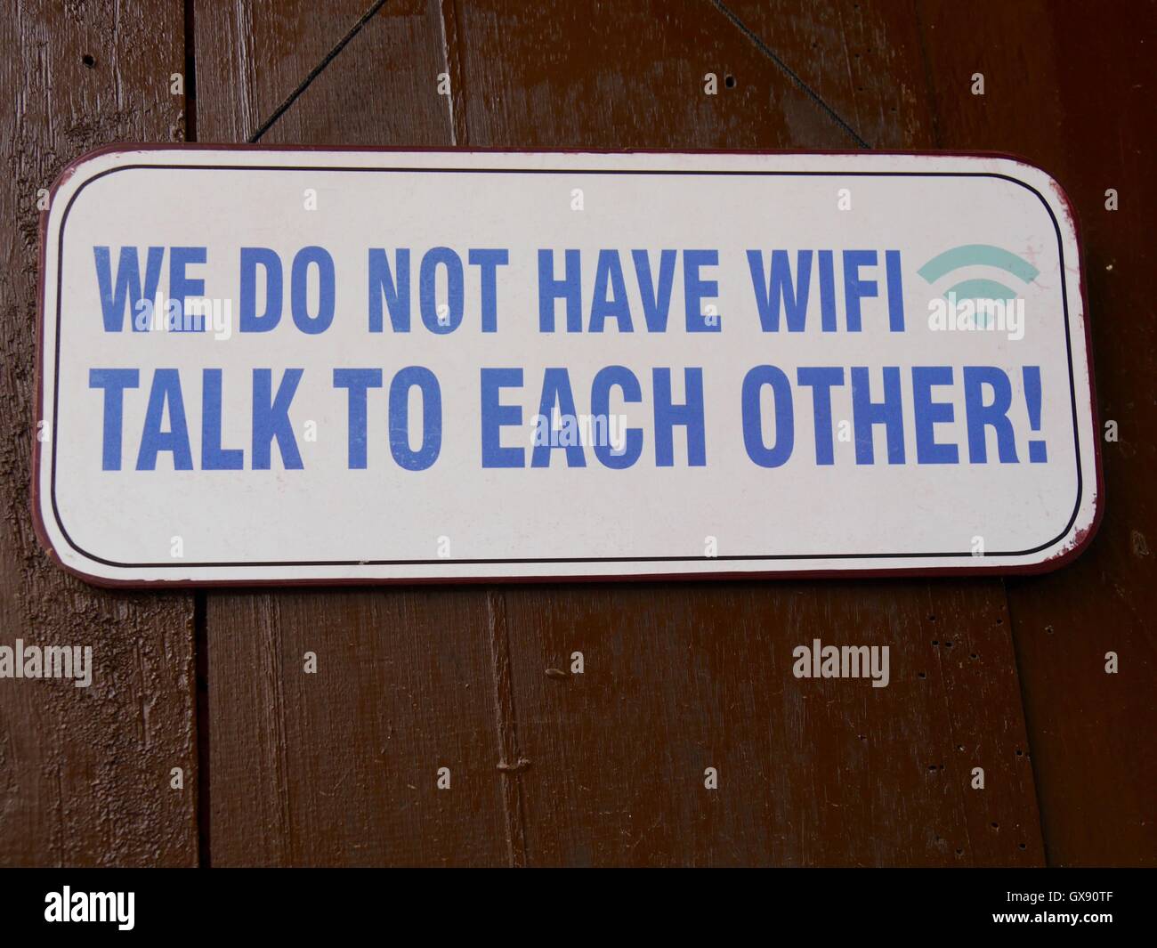 Cartello umoristico sul muro del caffè in Sri Lanka, che consiglia ai clienti di parlare non di scrivere Foto Stock