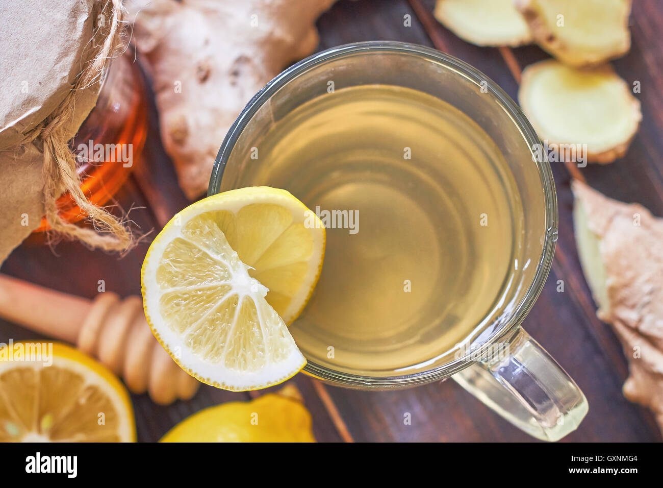 Il tè allo zenzero servito con miele e limone su un tavolo di legno. Vista superiore Foto Stock