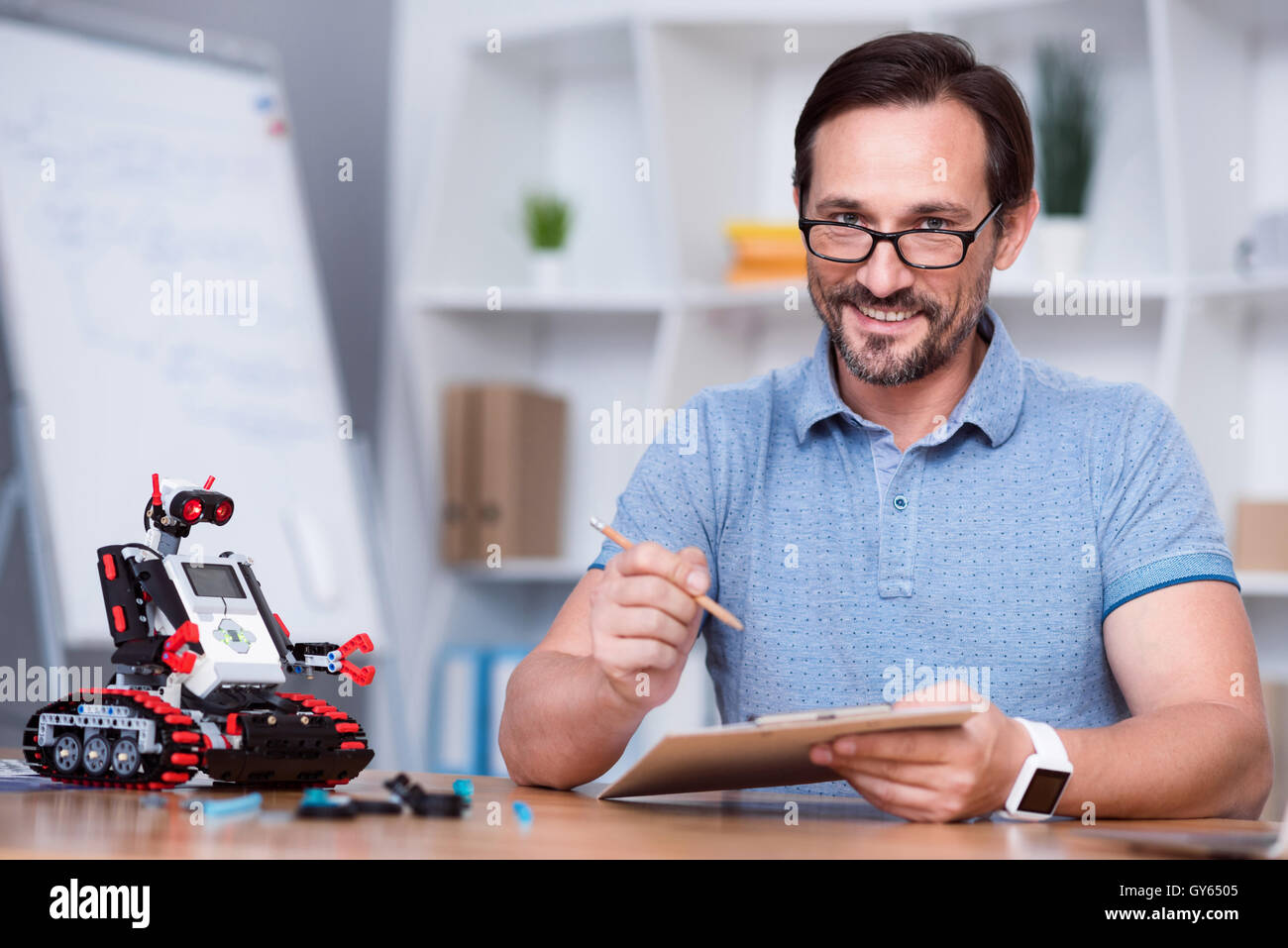 Senior positivo uomo robot di degustazione Foto Stock