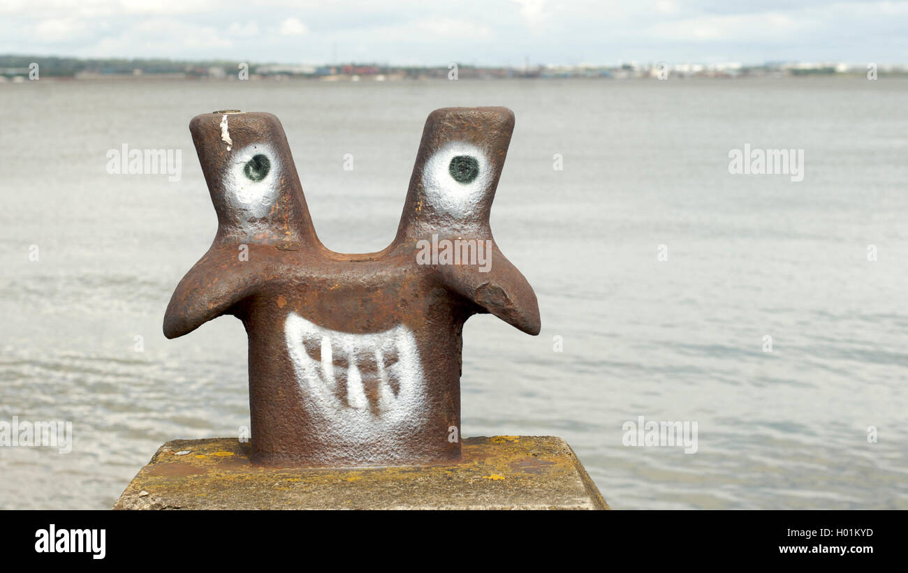 Divertente faccia verniciato a spruzzo su marine bollard ormeggio Foto Stock