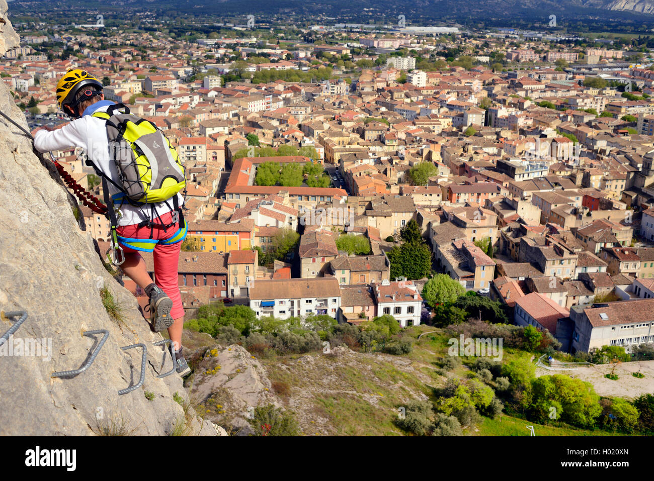 Scalatore sulla parete di roccia, città Cavaillon in background, via ferrata de CAVAILLON, Francia, Provenza, Cavaillon Foto Stock