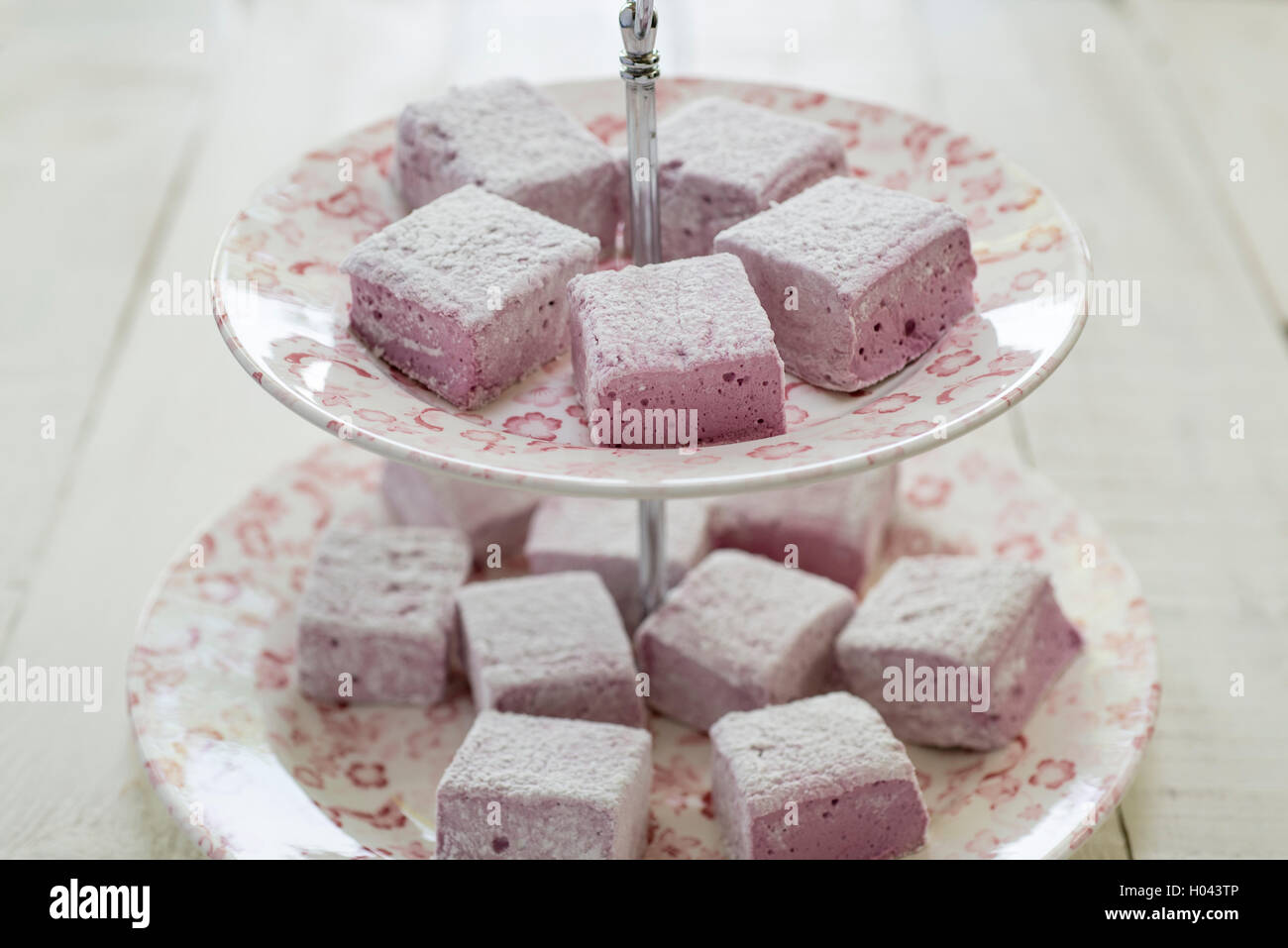In casa di blackberry e rose marshmallows su una torta rosa stand. Foto Stock