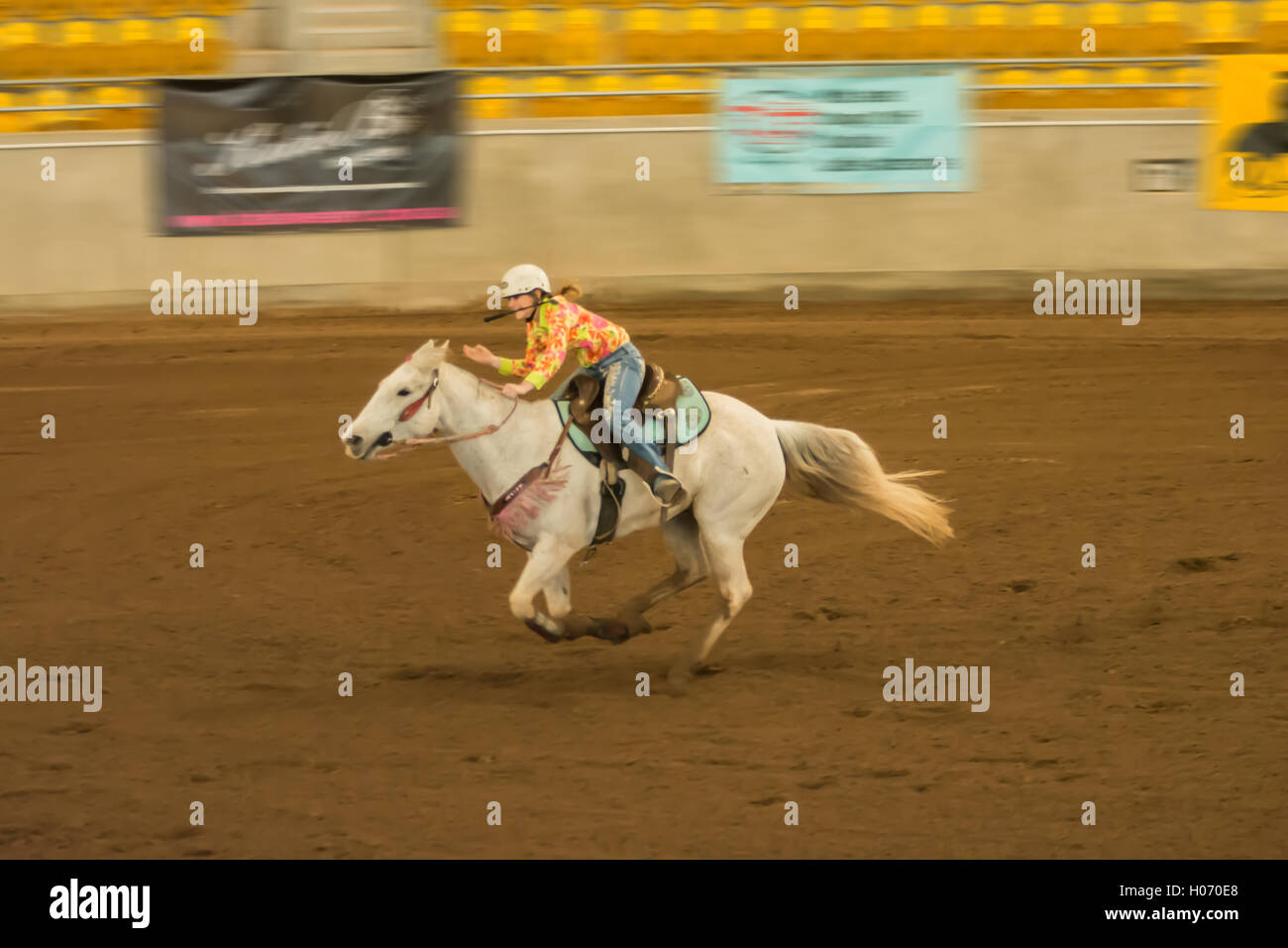 Barrel racing ad un indoor arena.giovane ragazza equitazione con frusta in bocca.tamworth Australia. Foto Stock