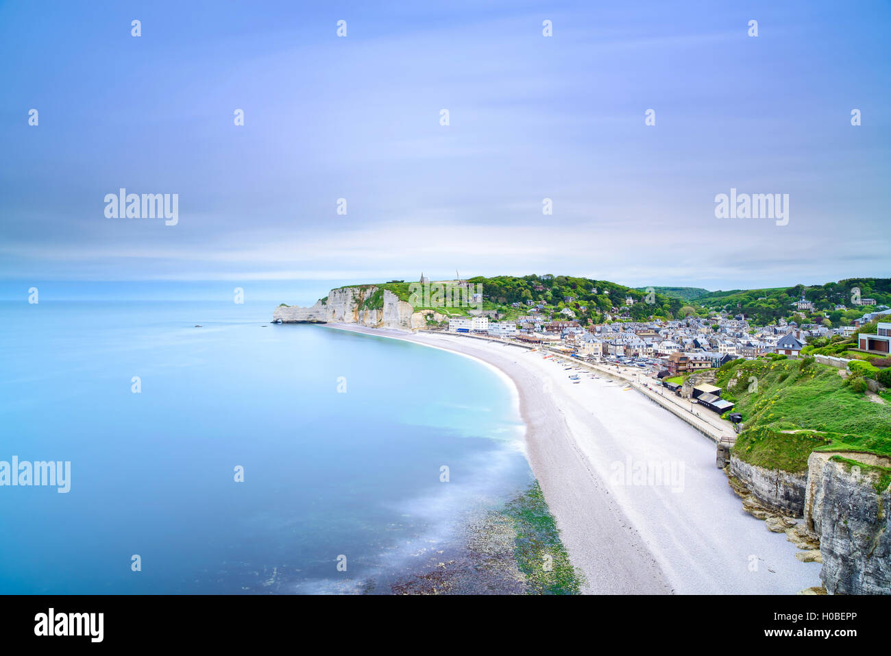 Etretat villaggio e la sua baia spiaggia, vista aerea dalla scogliera. La Normandia, Francia, Europa. Lunga esposizione. Foto Stock