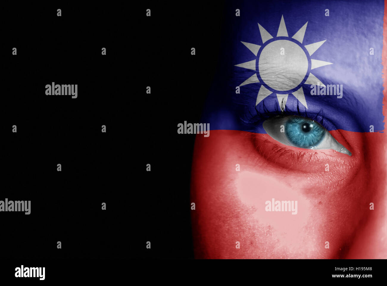 Una giovane donna con la bandiera di Taiwan dipinta sulla sua faccia sul suo modo ad un evento sportivo per mostrare il suo supporto. Foto Stock