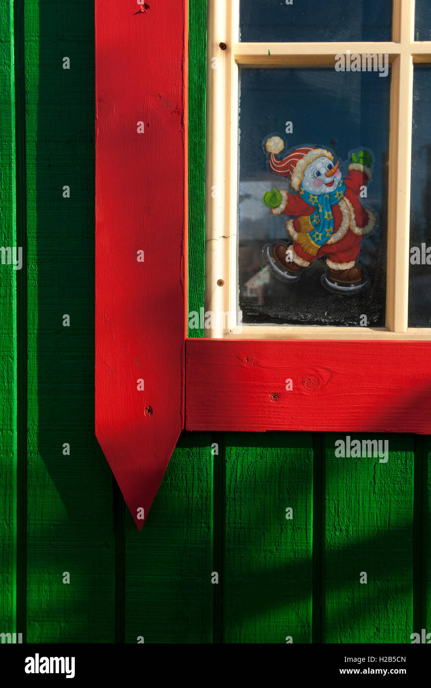 Un luminoso di colore verde e rosso Natale shack. Foto Stock