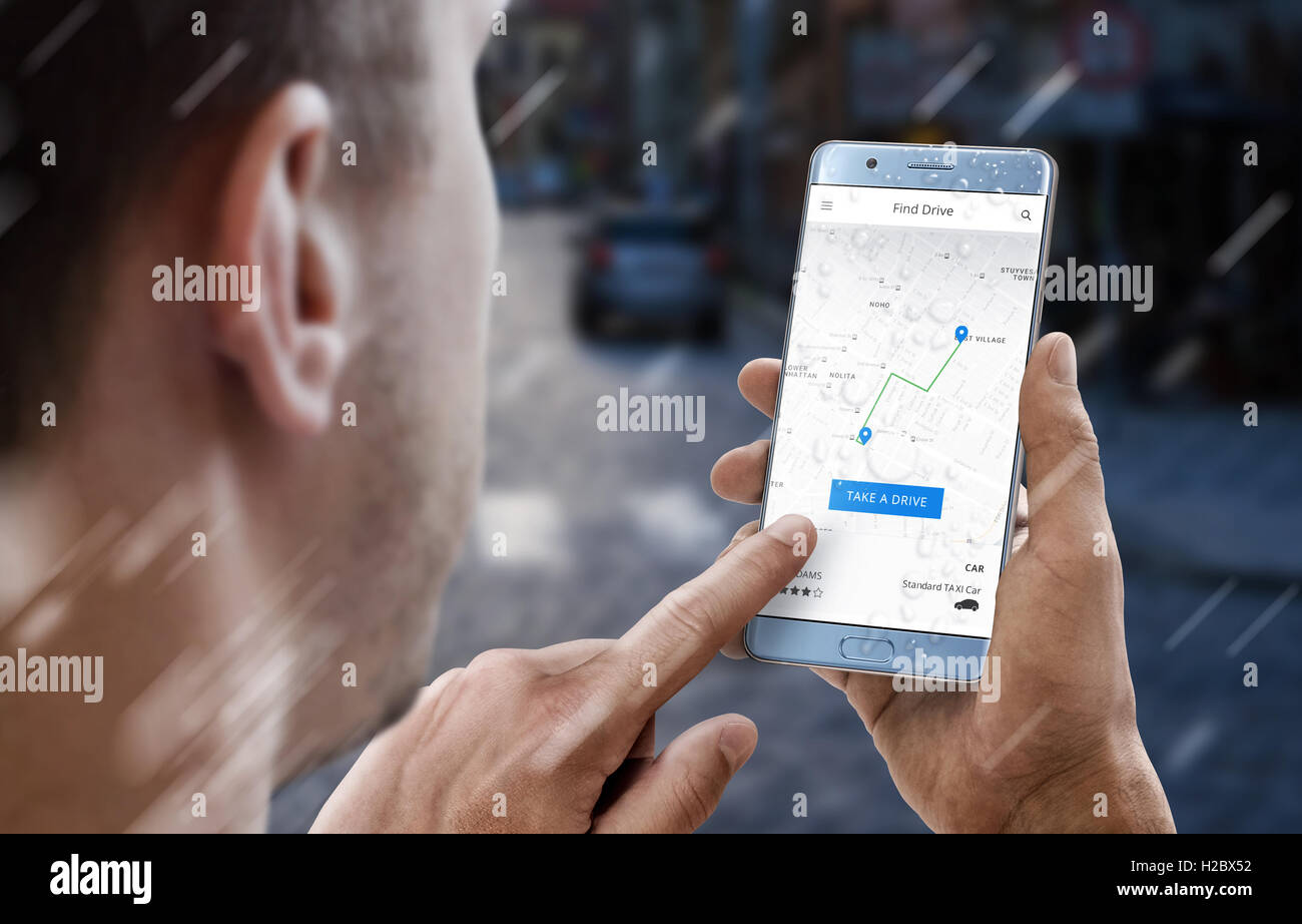 Uomo cerca autista noleggio su mobile app. Piove. Strada di città in background. Foto Stock