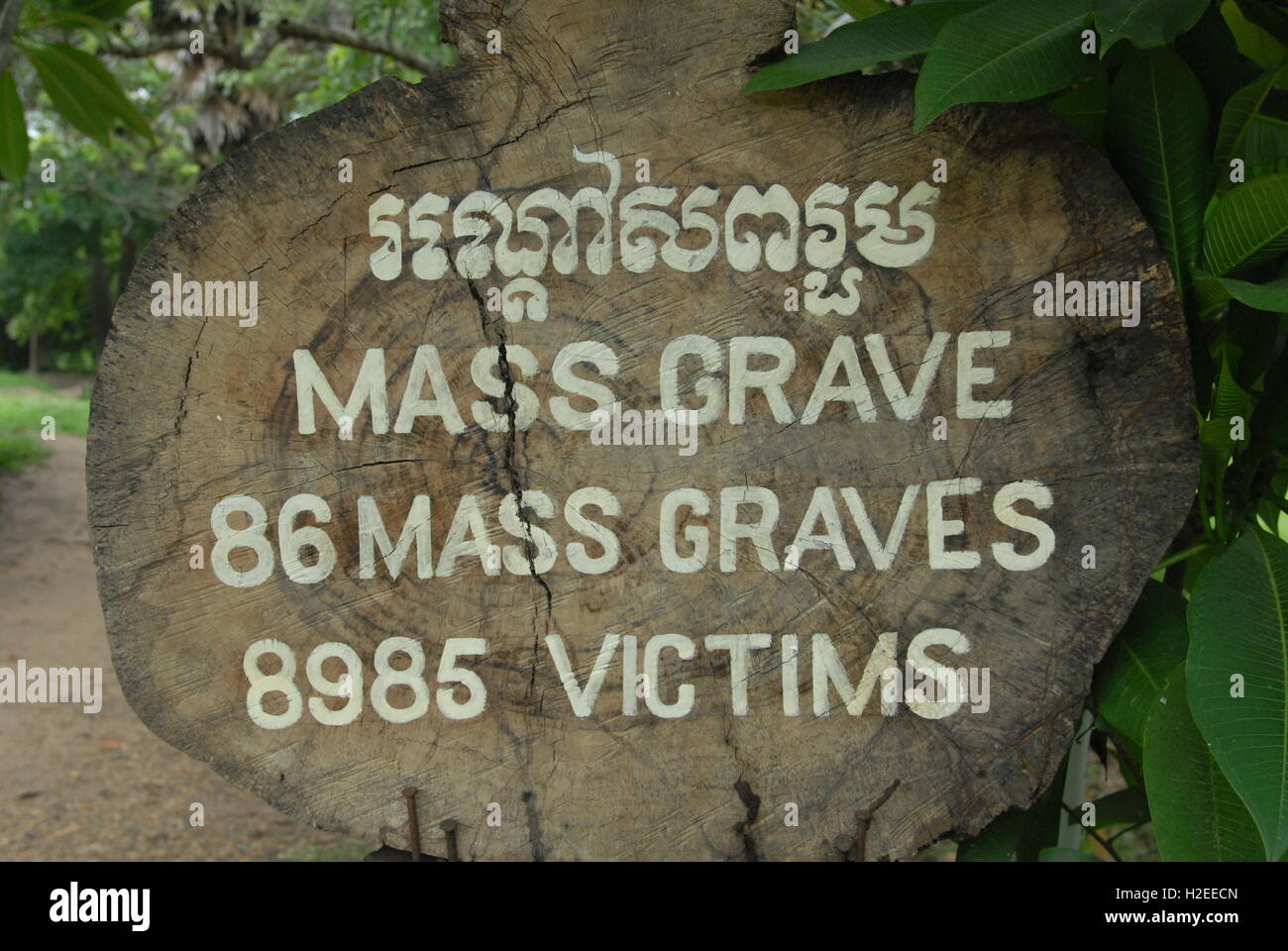 Bilingue massa di legno grave segno dei campi di sterminio, Choeung Ek Genocide Memorial, Phnom Penh Cambogia. Credito: Kraig Lieb Foto Stock
