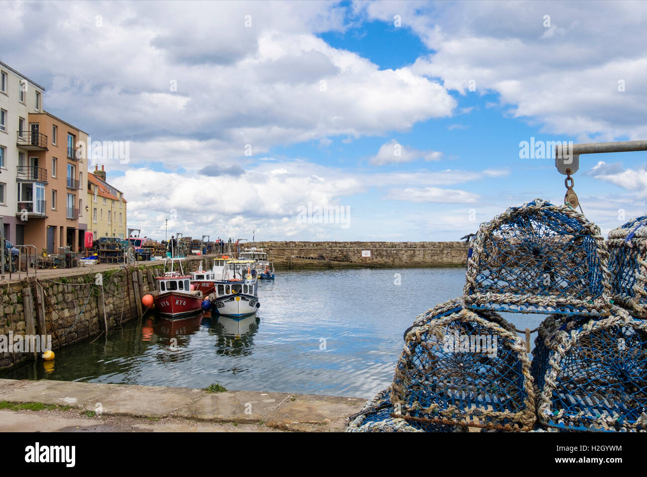 Barche da pesca ormeggiate nel porto di murata con aragosta pentole sul quay. Royal Burgh St Andrews Fife, Scozia, Regno Unito, Gran Bretagna Foto Stock