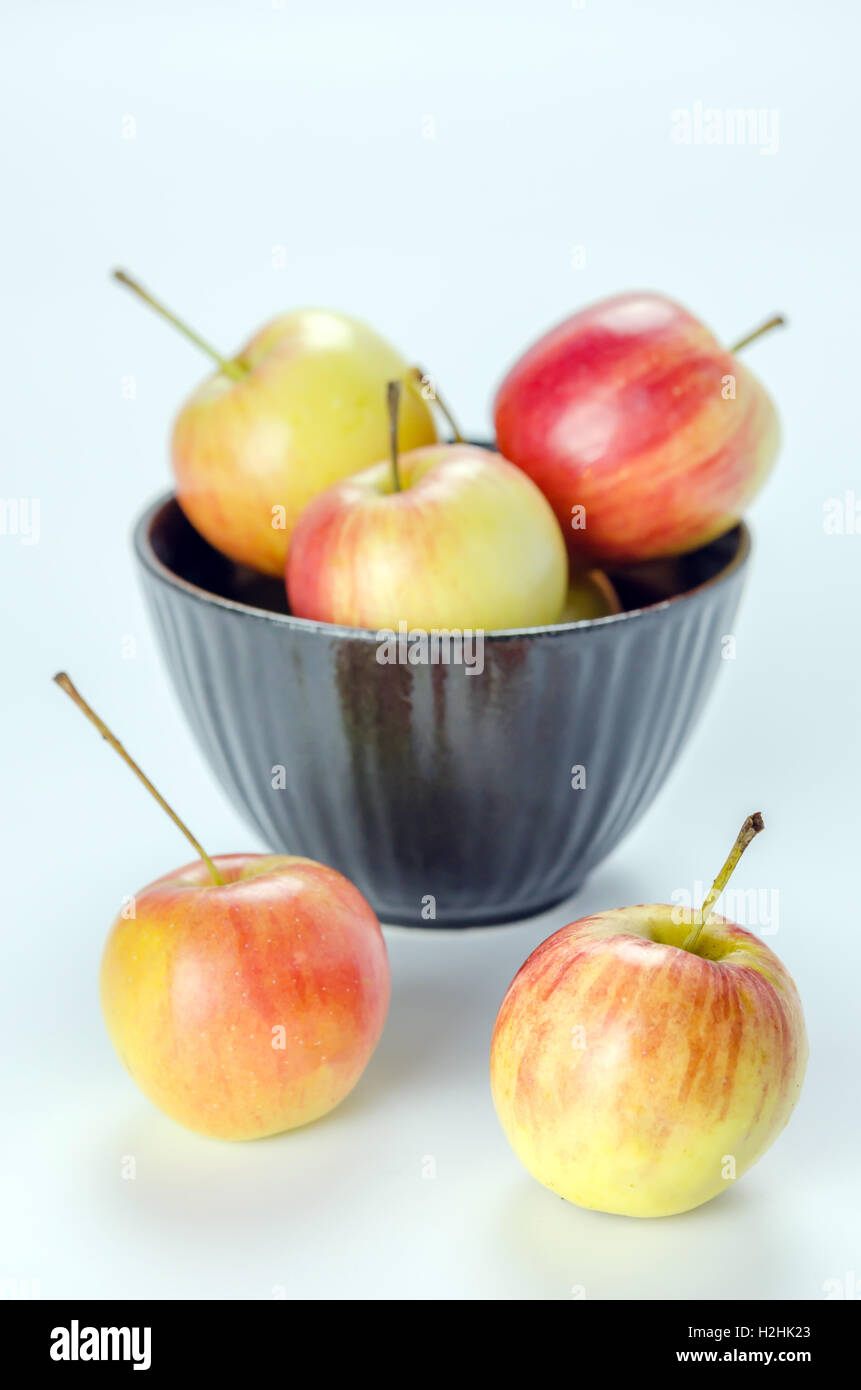 Rosso e giallo con apple ciotola nero , organica frutta fresca Foto Stock