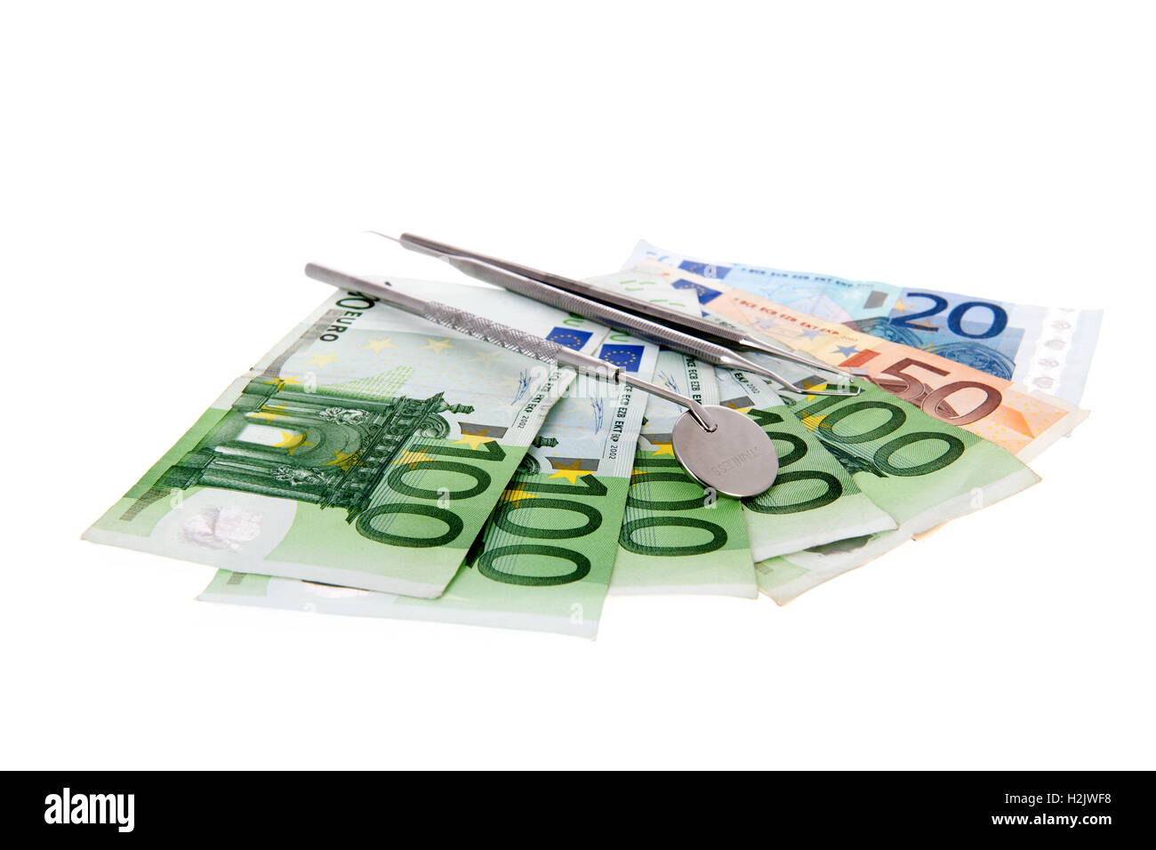 Gli attrezzi dal dentista sulle banconote Foto Stock