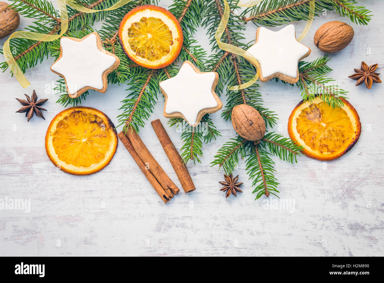 Decorazione di Natale bianco su uno sfondo di legno. Vista superiore del burro fatti in casa i dadi a forma di stella i biscotti con la glassa, pino, orange s Foto Stock