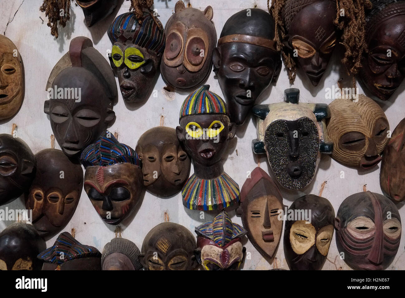 Maschere di legno africane esposte in un negozio di souvenir nell'isola di Zanzibar in Tanzania. Queste maschere sono repliche create per la vendita, poiché autentiche maschere cerimoniali si trovano raramente sul mercato aperto Foto Stock