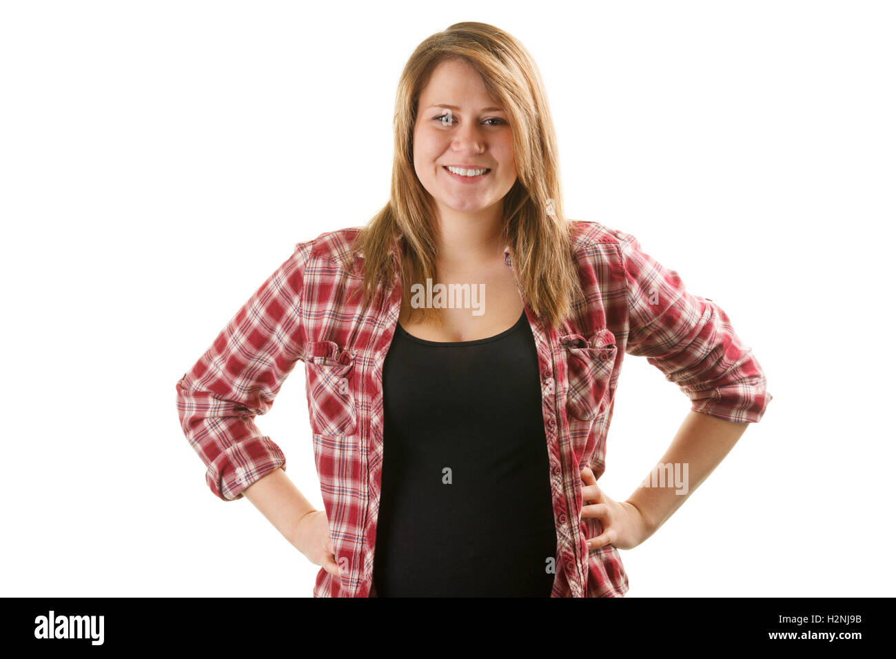 Donna attraente indossando red plaid shirt con mani sui fianchi Foto Stock