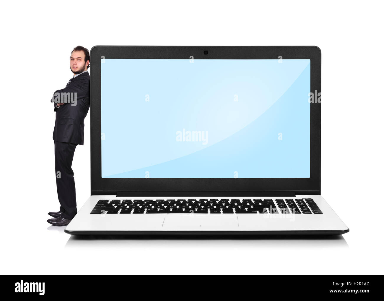 Imprenditore appoggiato su un computer portatile Foto Stock