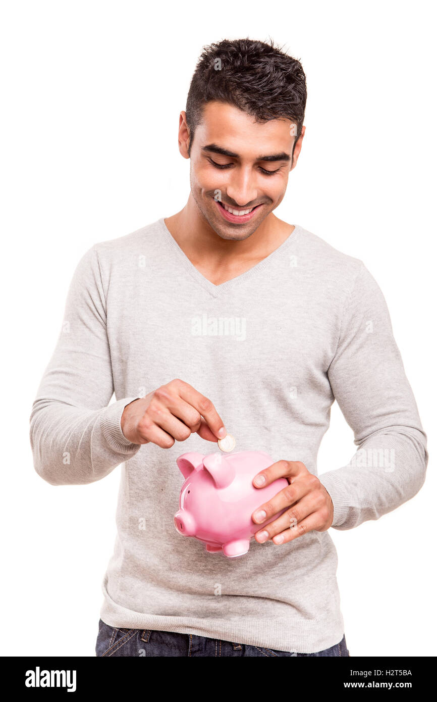 Uomo di risparmio di denaro per un salvadanaio Foto Stock