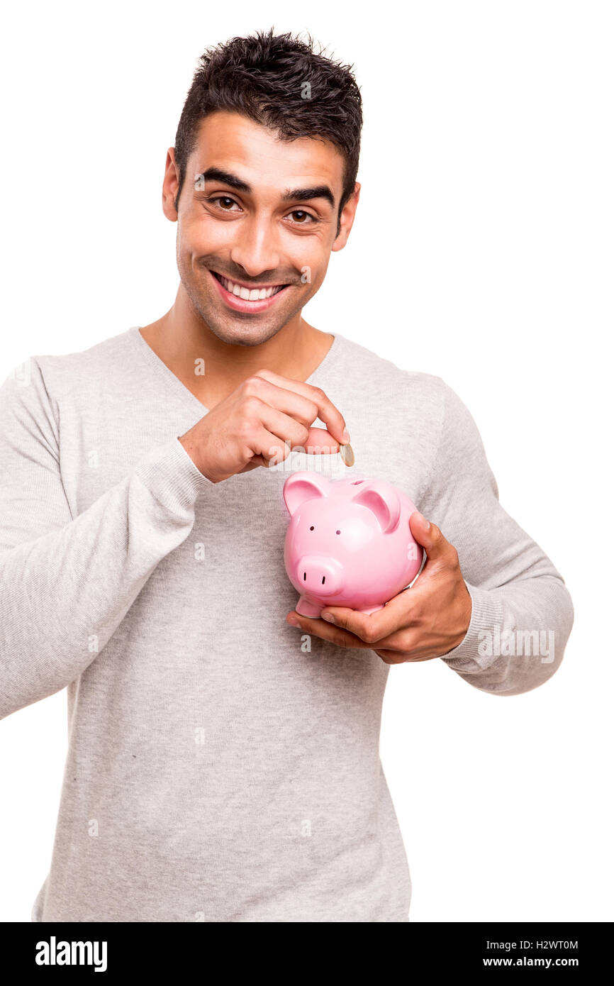 Uomo di risparmio di denaro per un salvadanaio Foto Stock