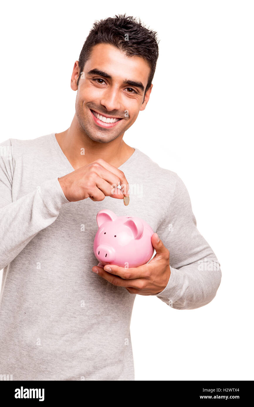 Uomo di risparmio di denaro per un salvadanaio Foto Stock
