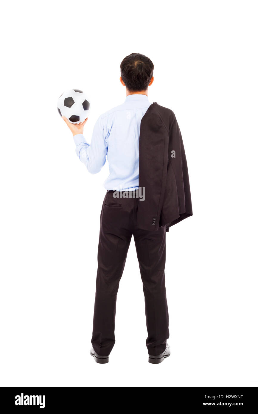 Vista posteriore del giovane uomo d affari con pallone da calcio Foto Stock