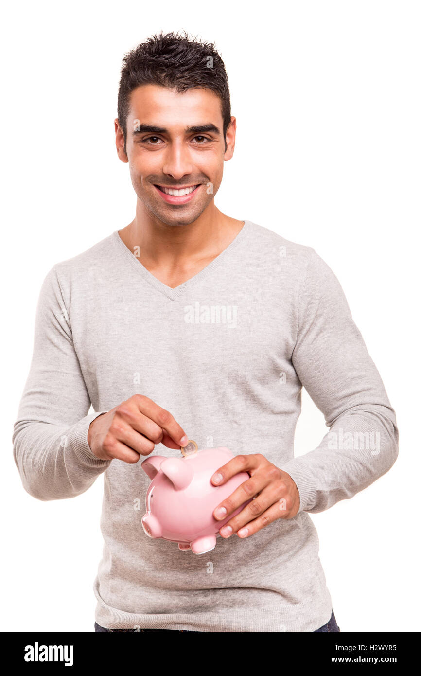 Uomo di risparmio di denaro per un salvadanaio Foto Stock