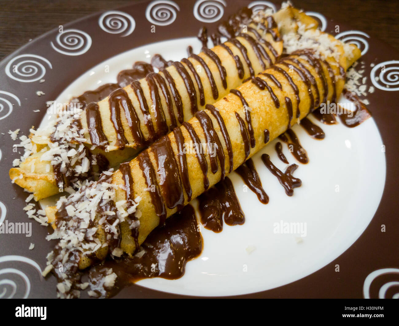 Frittelle spruzzata con il cioccolato Foto Stock