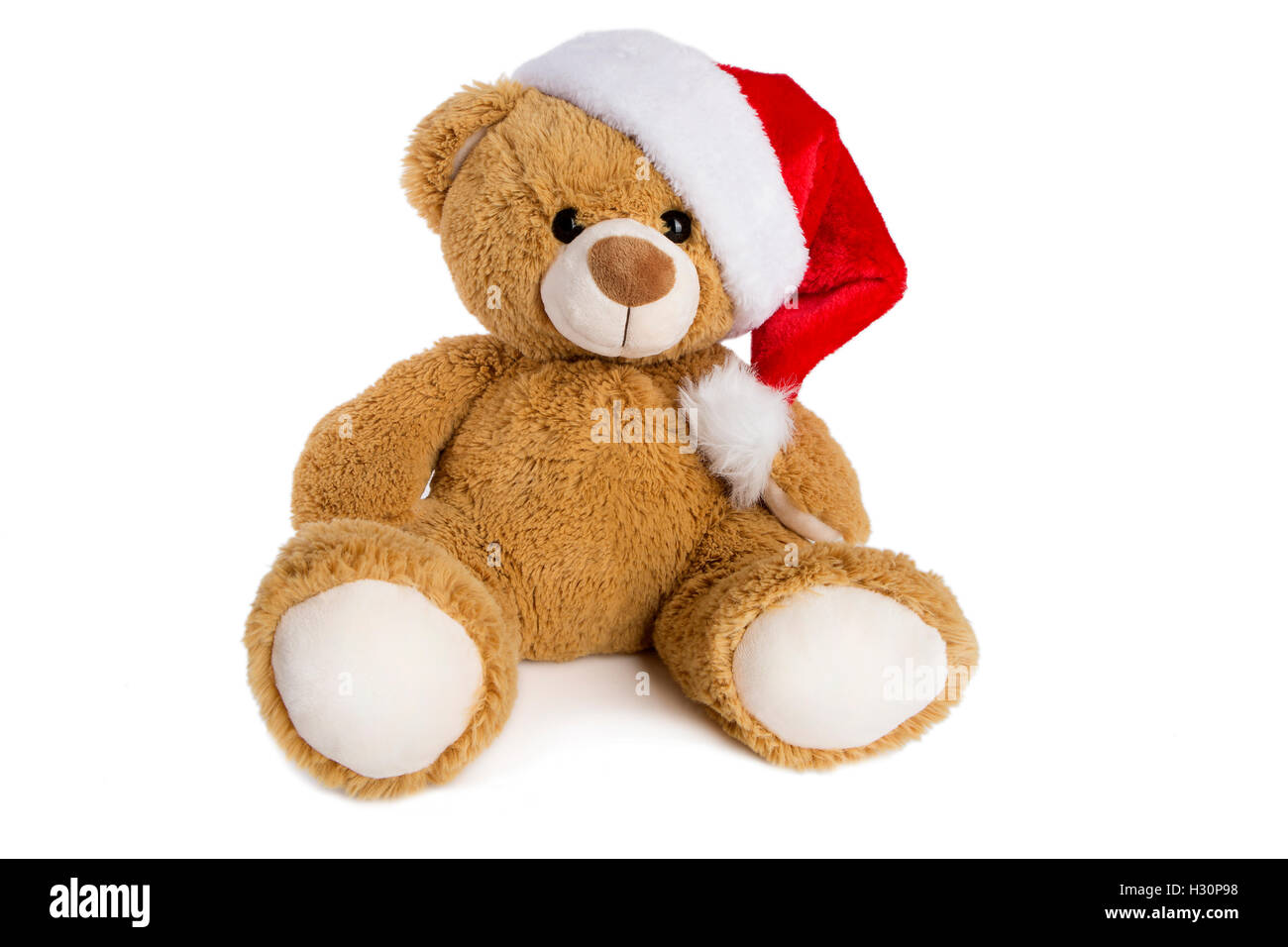 Orsacchiotto di peluche con Santa Claus hat isolato su uno sfondo bianco Foto Stock