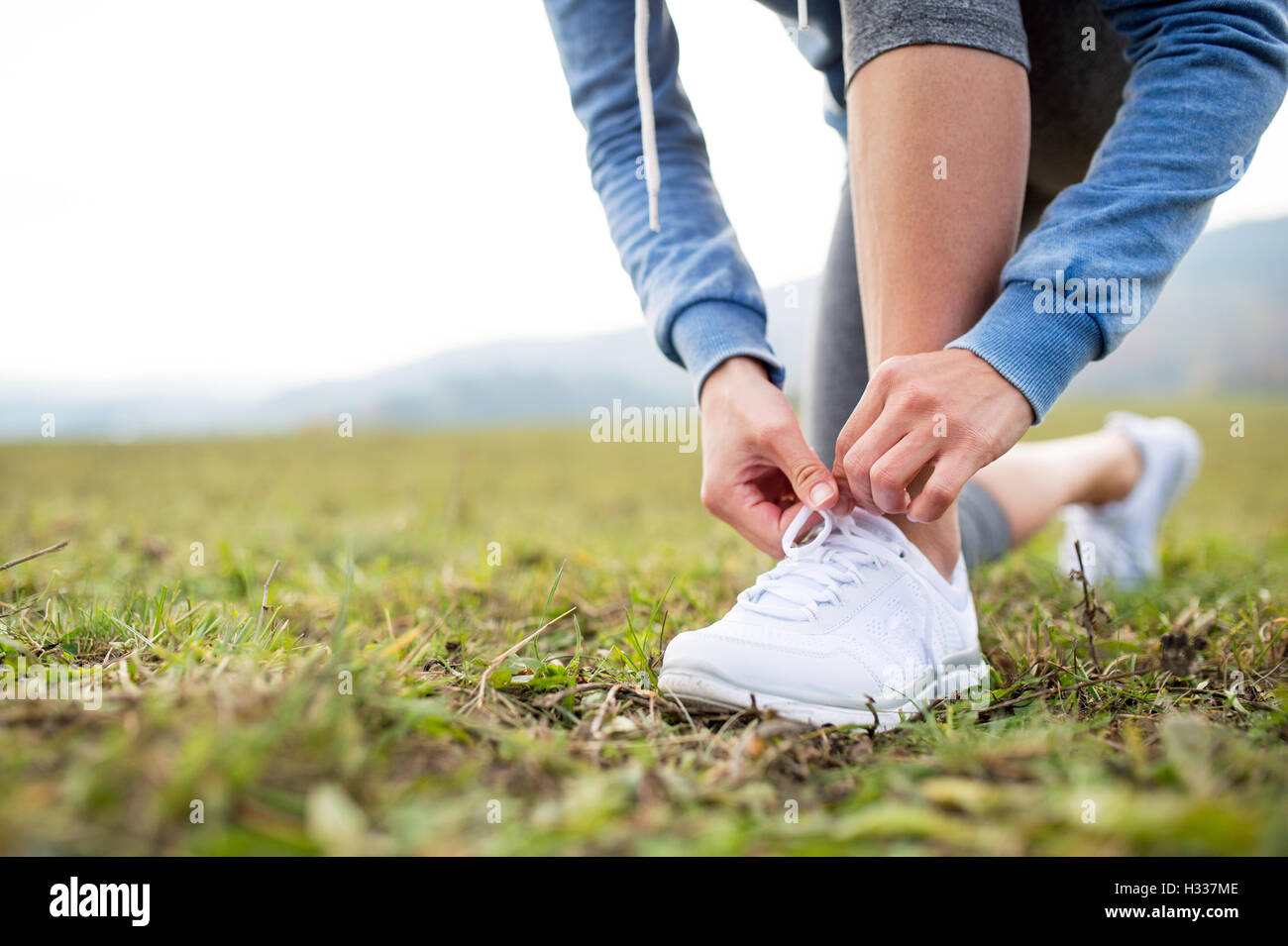 Close up di un irriconoscibile giovani runner lacci delle scarpe di legatura Foto Stock